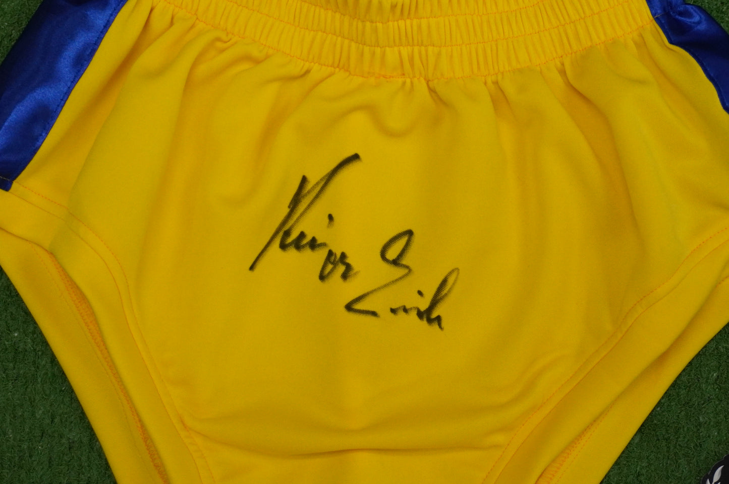 KEVIN VON ERICH SIGNED WRESTLING YELLOW and BLUE TRUNKS BAS COA