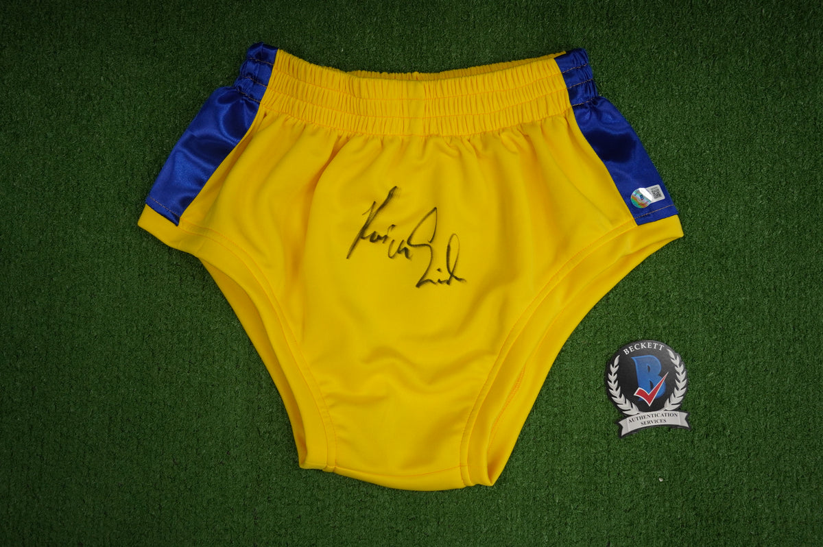 KEVIN VON ERICH SIGNED WRESTLING YELLOW and BLUE TRUNKS BAS COA