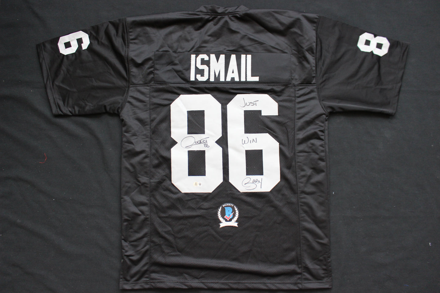ROCKET ISMAIL RAIDERS SIGNED BLACK JERSEY w/JUST WIN BABY BAS COA