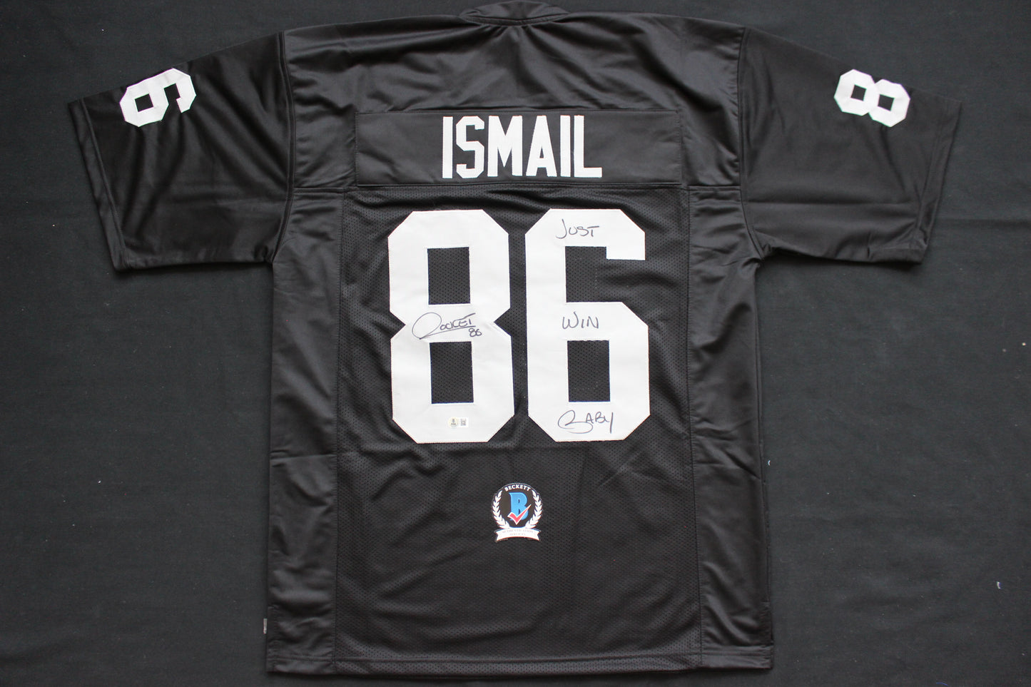 ROCKET ISMAIL RAIDERS SIGNED BLACK JERSEY w/JUST WIN BABY BAS COA