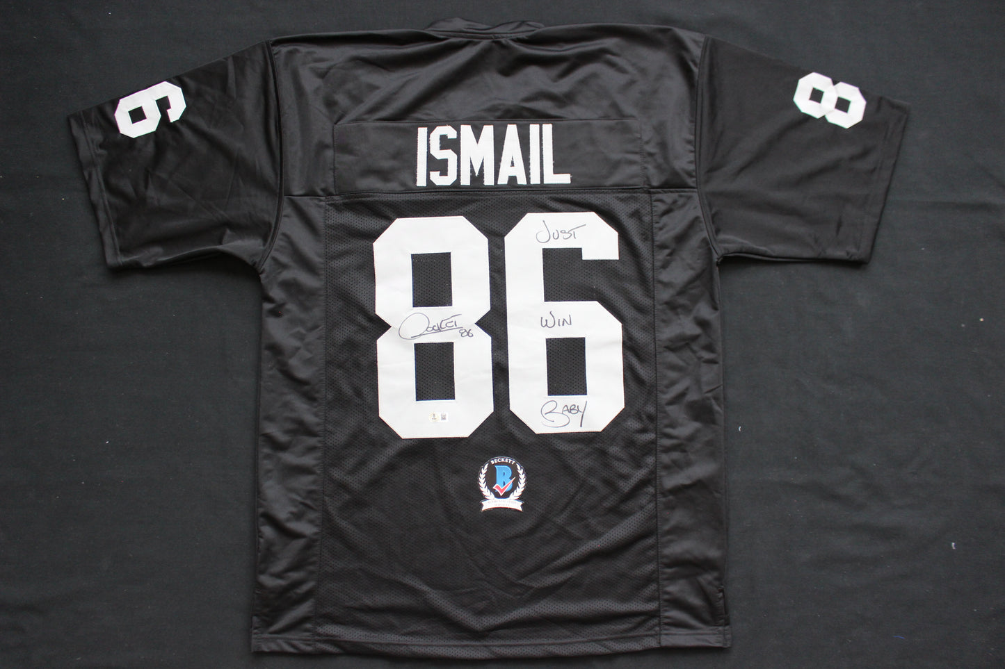 ROCKET ISMAIL RAIDERS SIGNED BLACK JERSEY w/JUST WIN BABY BAS COA