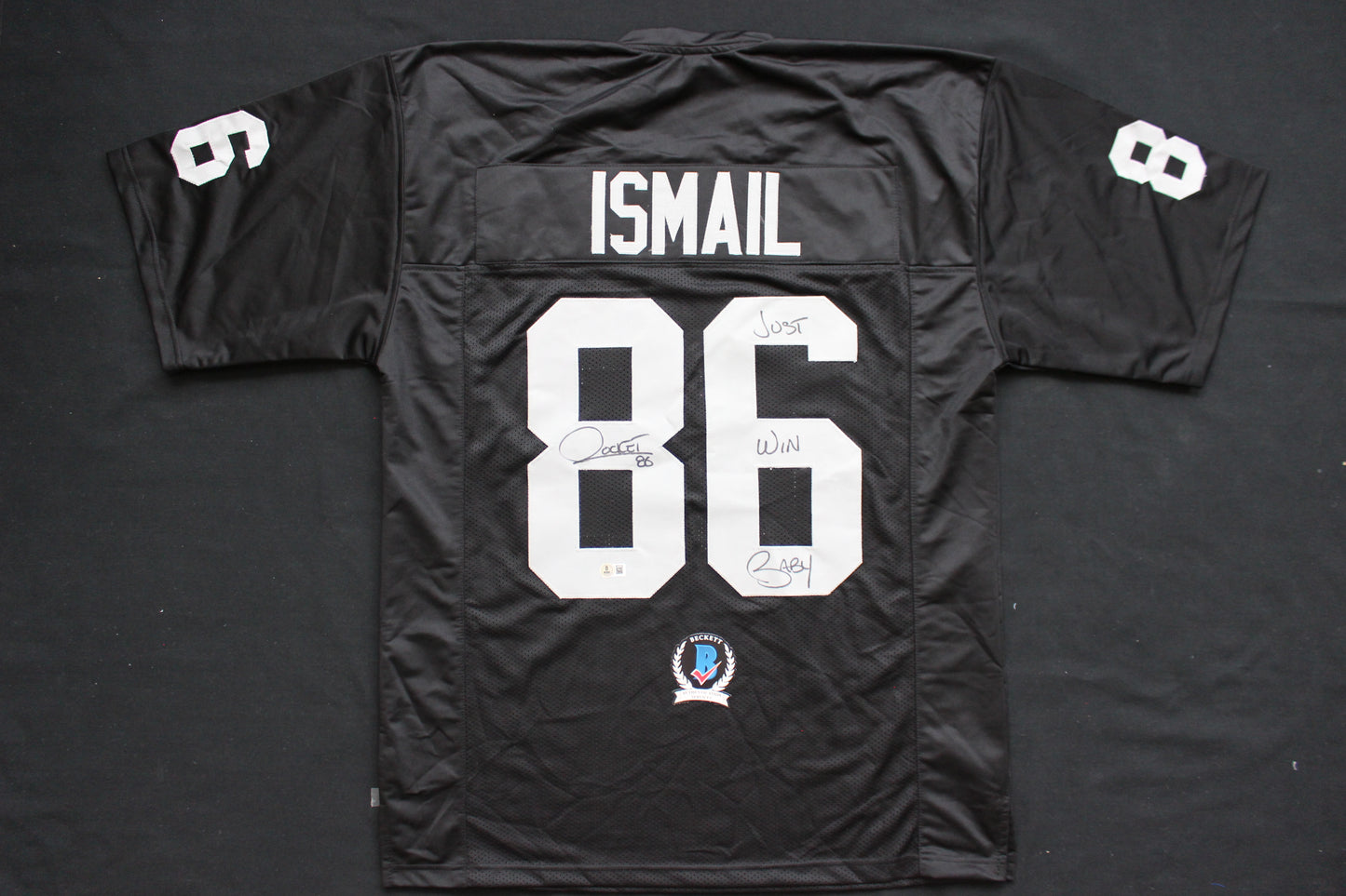 ROCKET ISMAIL RAIDERS SIGNED BLACK JERSEY w/JUST WIN BABY BAS COA