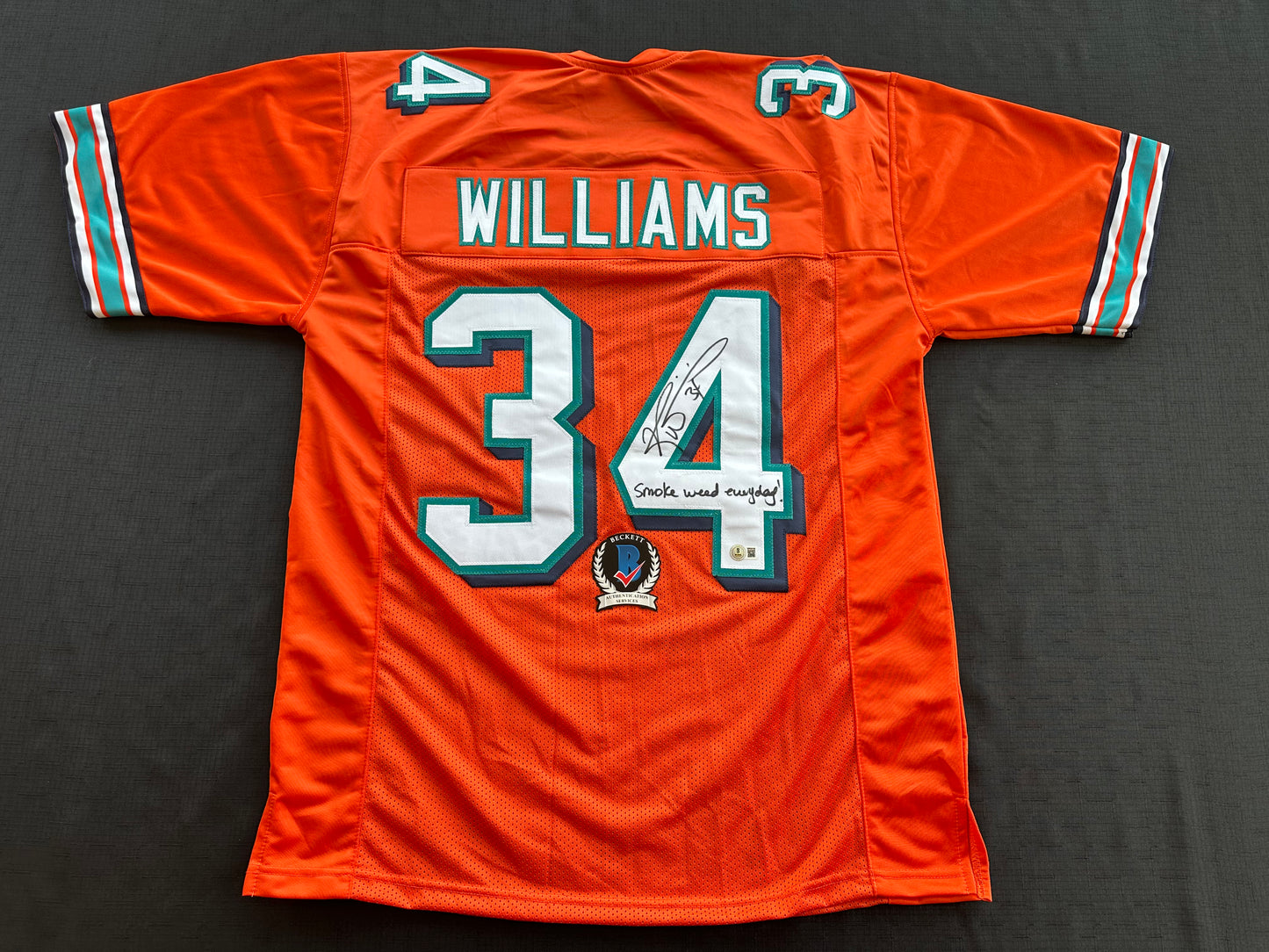 RICKY WILLIAMS ORANGE FOOTBALL JERSEY Miami Dolphins w/"Smoke Weed Everyday" BAS