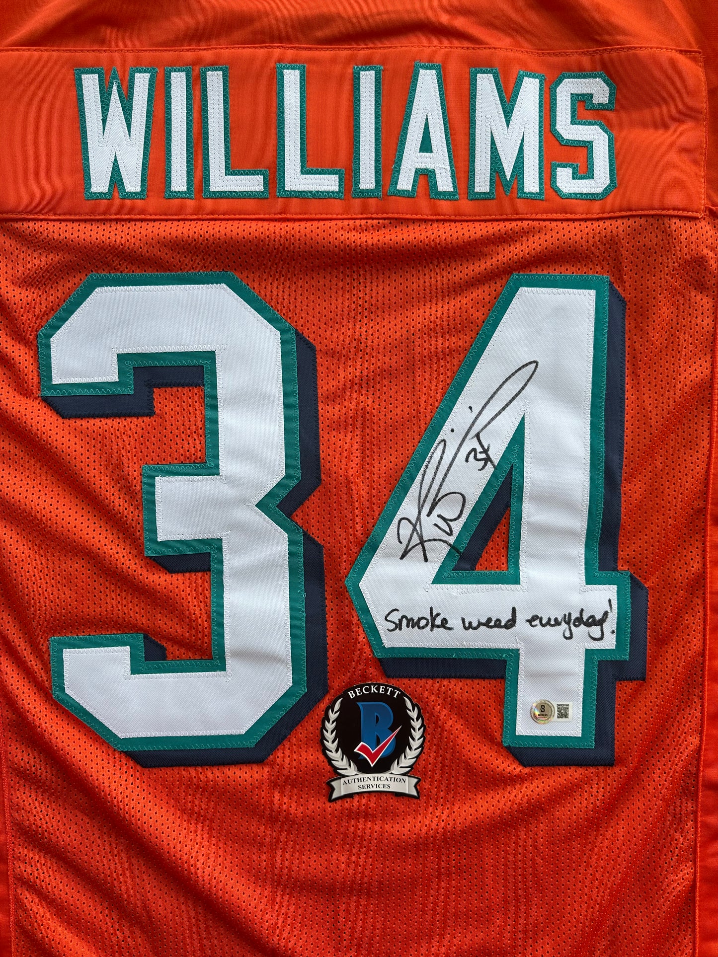 RICKY WILLIAMS ORANGE FOOTBALL JERSEY Miami Dolphins w/"Smoke Weed Everyday" BAS