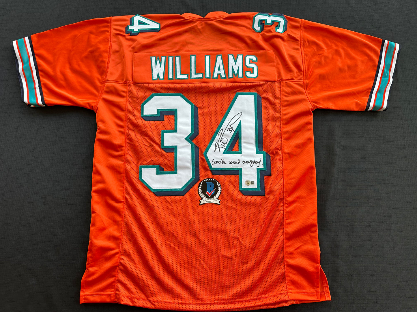 RICKY WILLIAMS ORANGE FOOTBALL JERSEY Miami Dolphins w/"Smoke Weed Everyday" BAS